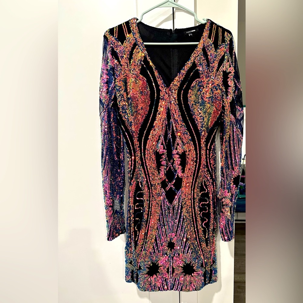 This sequin mini dress is sure to turn heads at a party or any function.